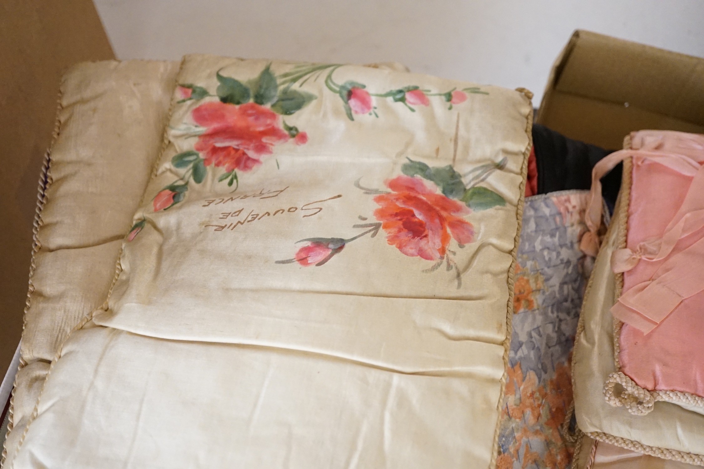 A large collection of mixed European textiles including ribbon worked pyjama cases, Indian painted textiles, a sample book of braidings etc